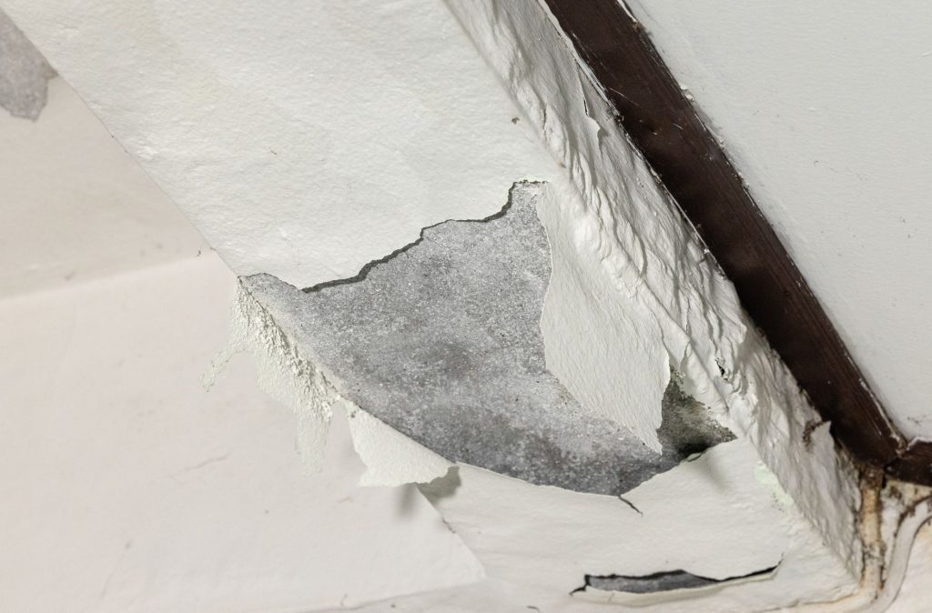 Visible cracks in a concrete slab caused by an underground water leak